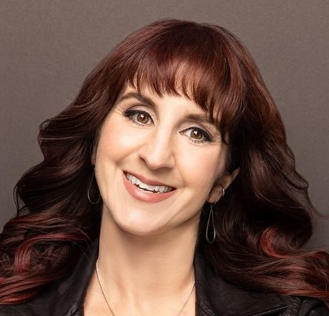 Headshot of Val Head, a white woman with dark brown hair